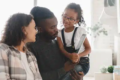 happy couple being engaged in child's interest to demonstrate Openness in Adoption