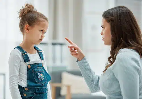 a mother lecturing an upset girl
