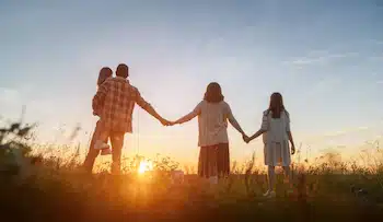 a family of four watching the sunset