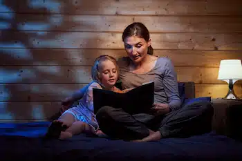a mother reading a book to her child