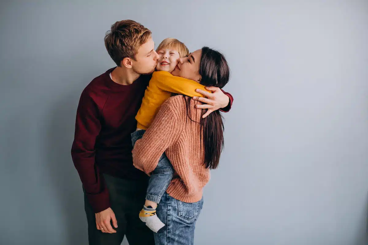Couple holding their adopted kid
