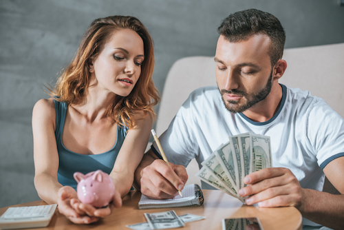 couple assessing their financial capacity in adopting a newborn baby