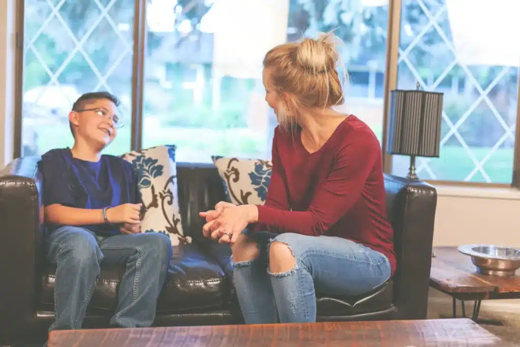 A boy talks with his adoptive parent.