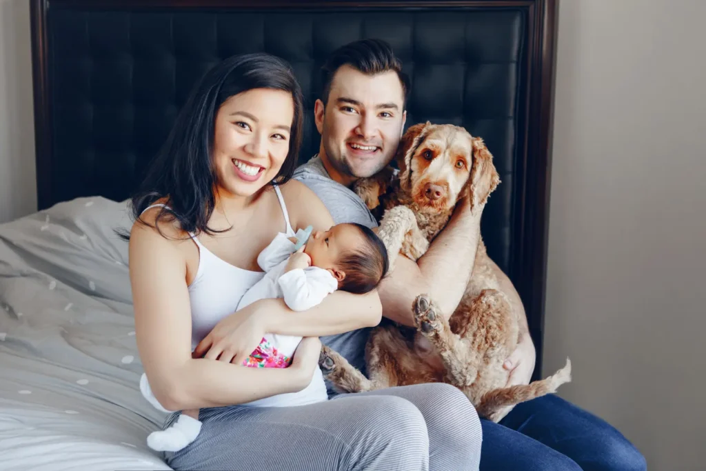 Couple with their new born baby and their dog