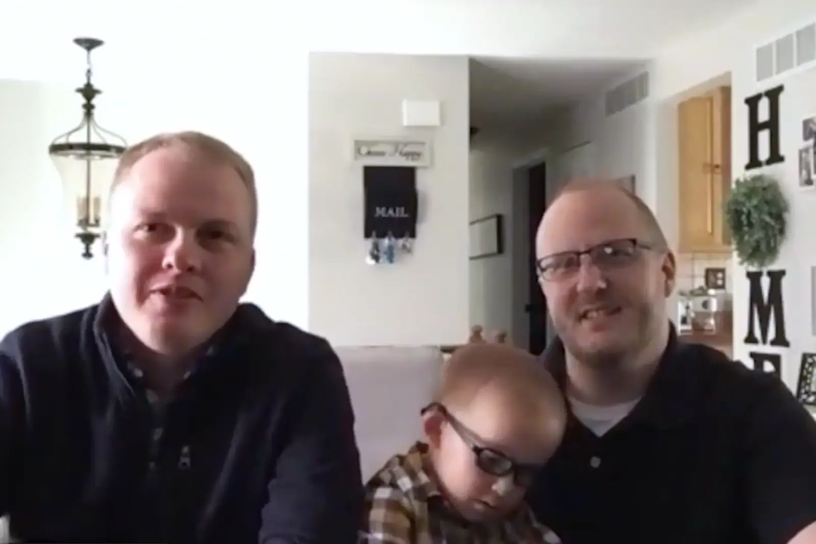a couple with their son on a video call