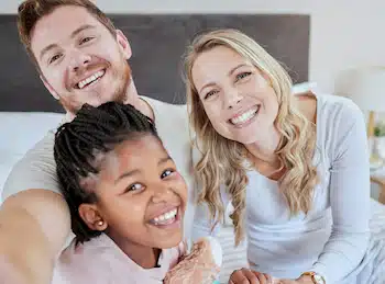 Cross-Cultural Adoption: family picture of a couple who adopted a cross-cultural daughter