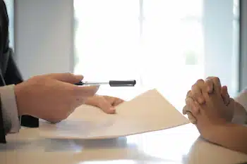 Legal Aspects of Making an Adoption Plan : legal counsel handing over a pen to signee