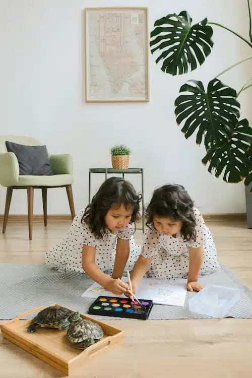 twin sisters paying paint together