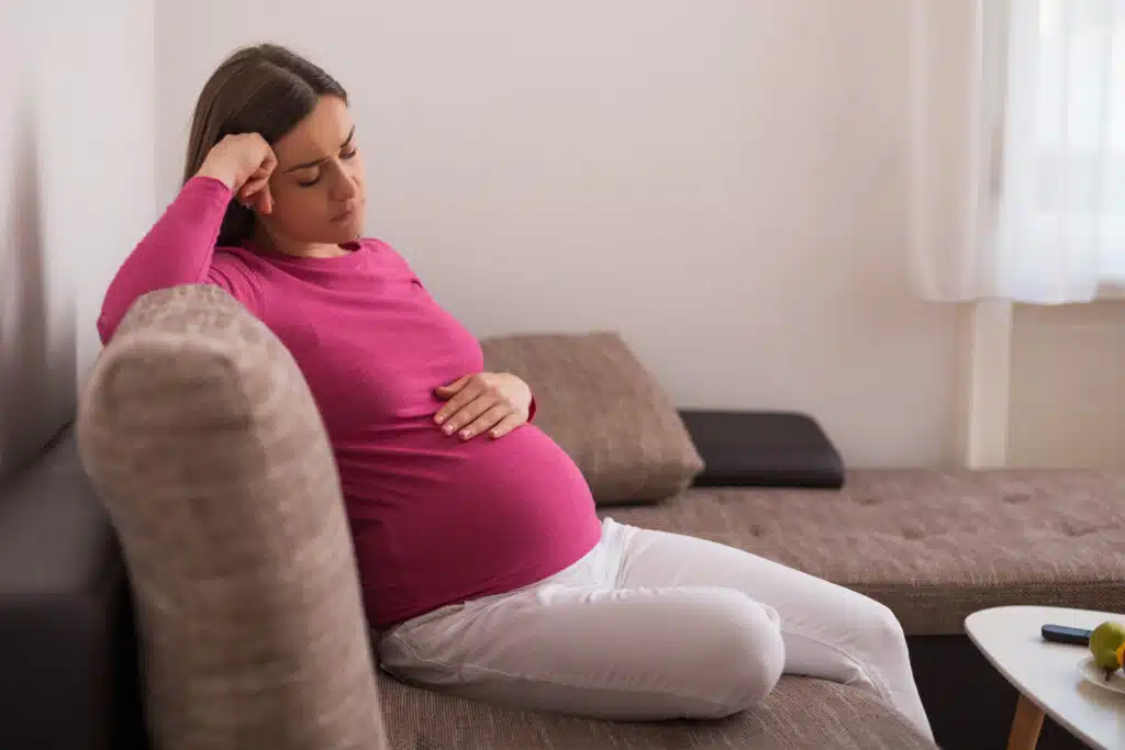 pregnant woman thinking on how to give her baby for adoption