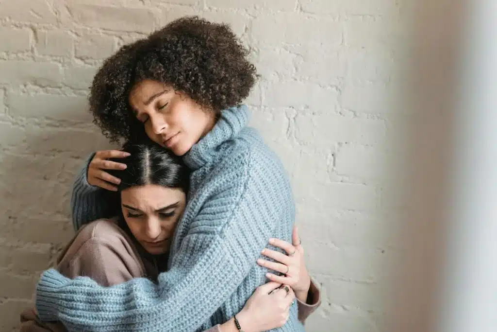 Black woman comforting upset friend