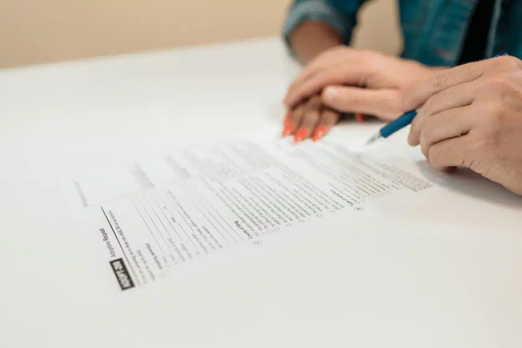 Person Writing on White Paper