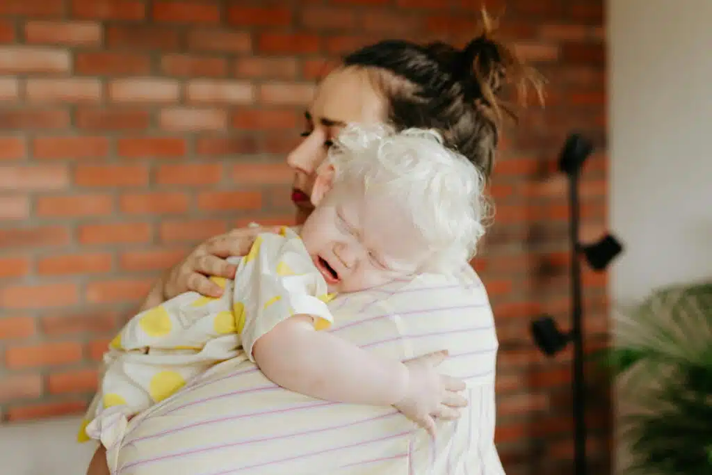 Close-Up Shot of a Woman Carrying Her Baby