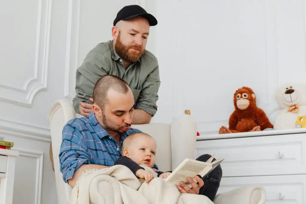 LGBT couple teaching their adopted child to read