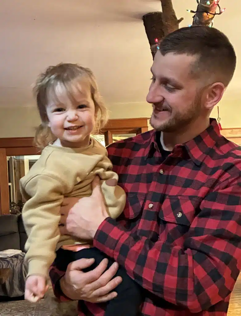 Man holding the child smiling